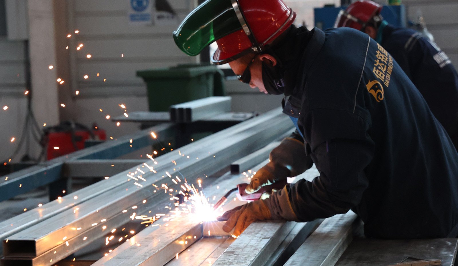 Baida factory worker welding the steel house frame